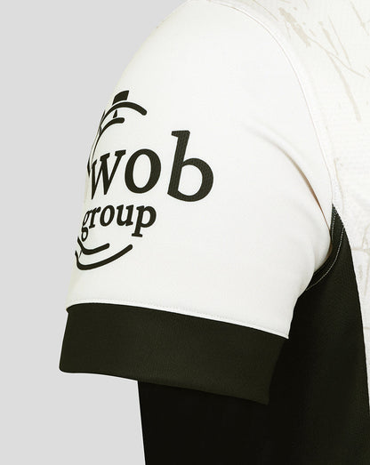 Sleeve close-up of the Saracens replica away shirt in white with a black cuff and sponsor logo.