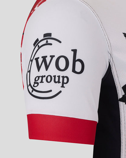 Close up of a white Saracens Showdown replica shirt sleeve with red cuff and wob group graphic