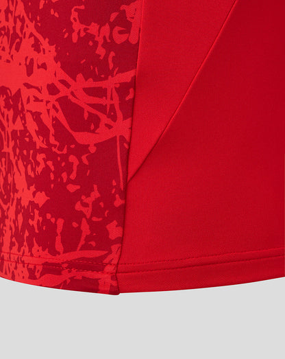 Close up of red Saracens midlayer fabric with abstract print and stitched hem