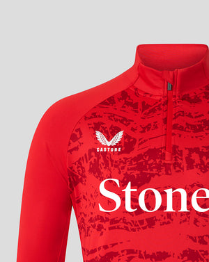 Close-up of red Saracens midlayer chest area showing Castore logo and abstract print