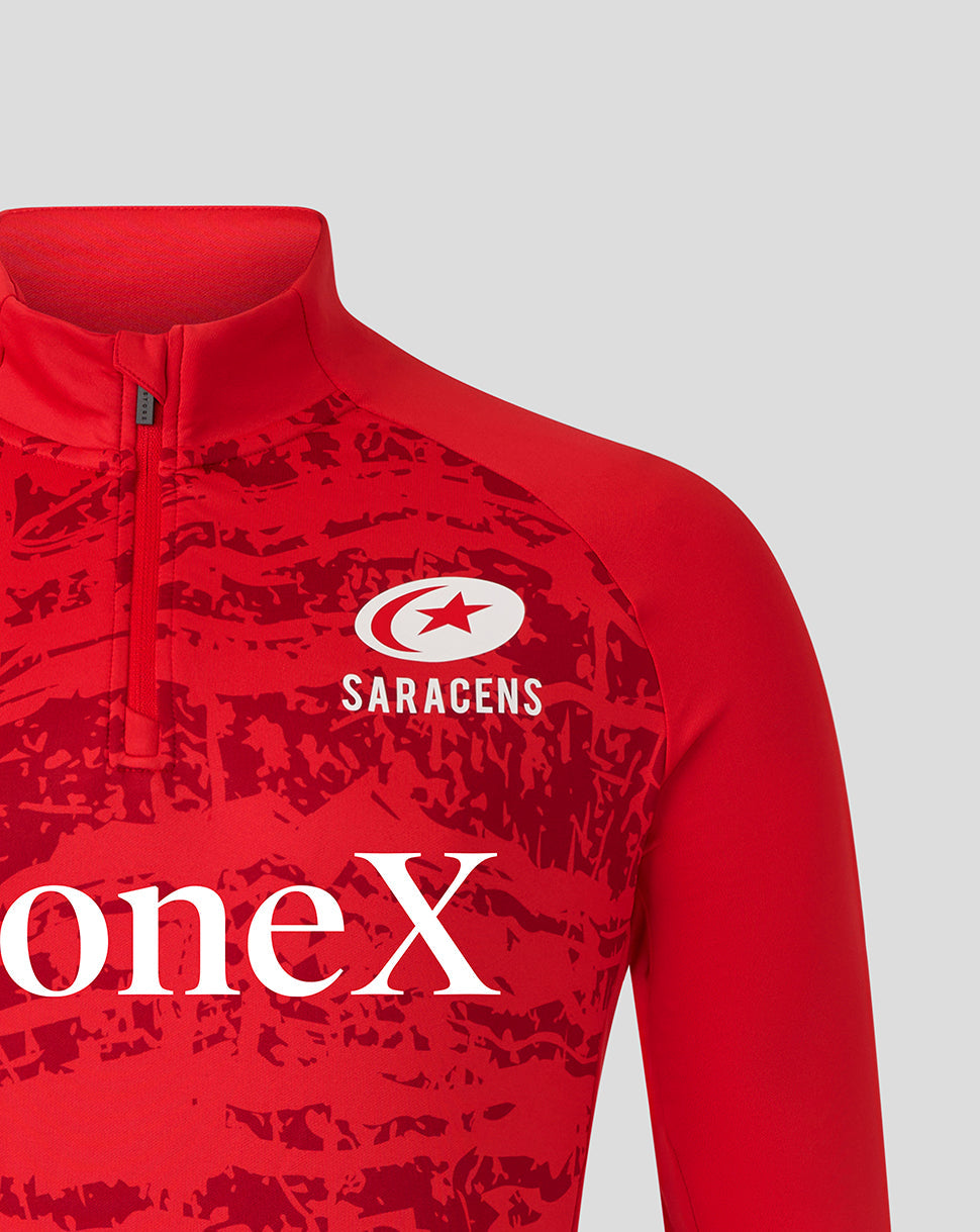 Close-up of red midlayer chest featuring Saracens crest and large StoneX branding