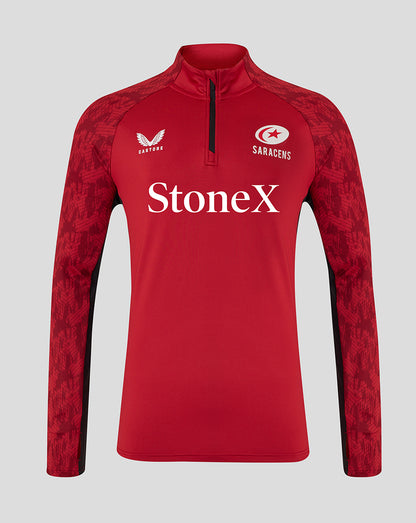 Front view of red Saracens training top with StoneX sponsor, Castore logo, and patterned sleeves with a quarter-zip neck.