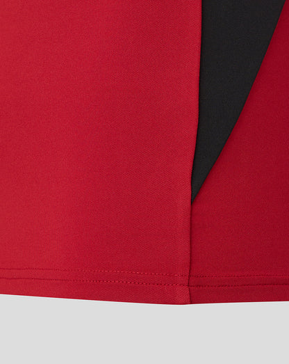 Close up of the rhythmic red Saracens training drill top showing a black side panel.