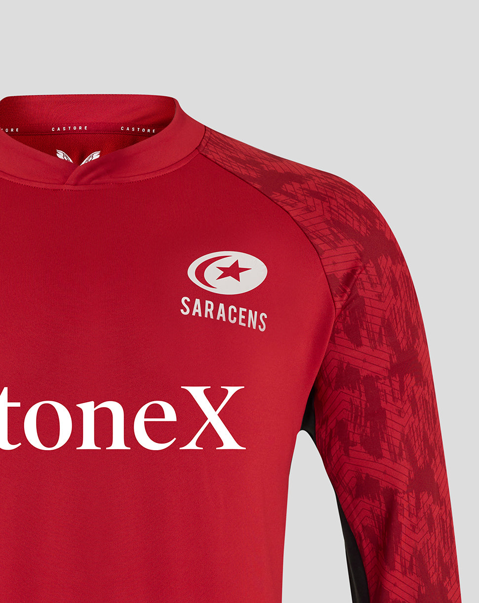 Front view of red Saracens training top showing club crest on the chest and StoneX sponsor text across the torso.