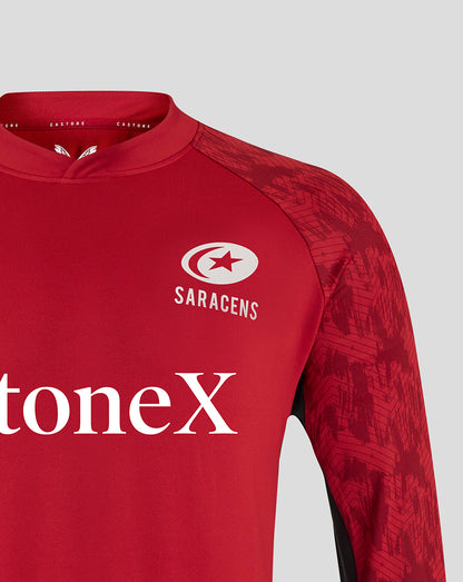 Front view of red Saracens training top showing club crest on the chest and StoneX sponsor text across the torso.