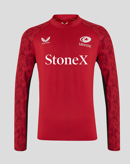 Front view of red Saracens training drill top with patterned sleeves and Castore logo on left chest and Saracens crest on right.