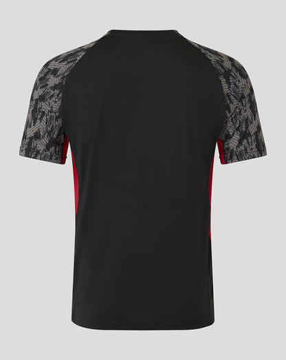 Back view of Saracens training short sleeve tee in black with grey patterned raglan sleeves and red side panels.