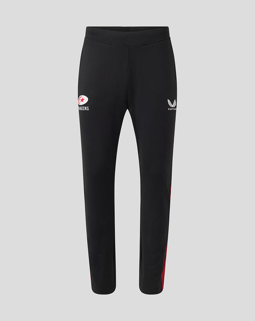 Front view of black Saracens training pants with a white circular logo on the left thigh and red side detailing.