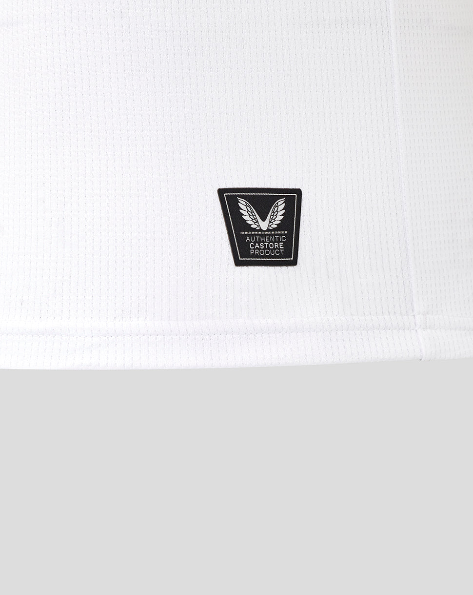 Close-up of white jersey fabric with black authentic Castore product patch