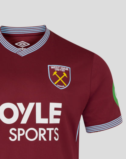 Close up of the maroon West Ham home shirt showing a blue striped collar, Umbro logo, and the club crest on the chest