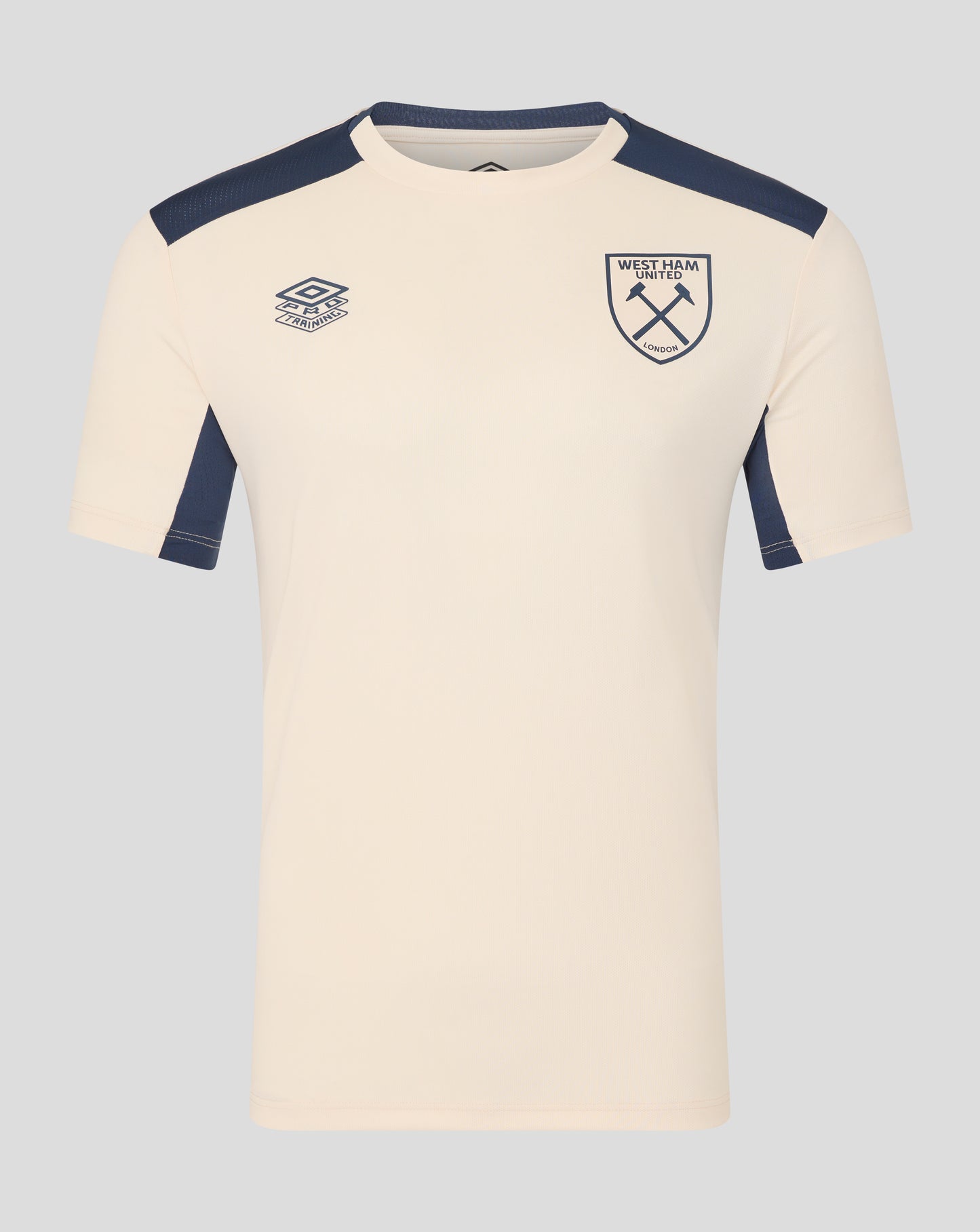 Cream training shirt with navy shoulder panels and West Ham crest on the chest