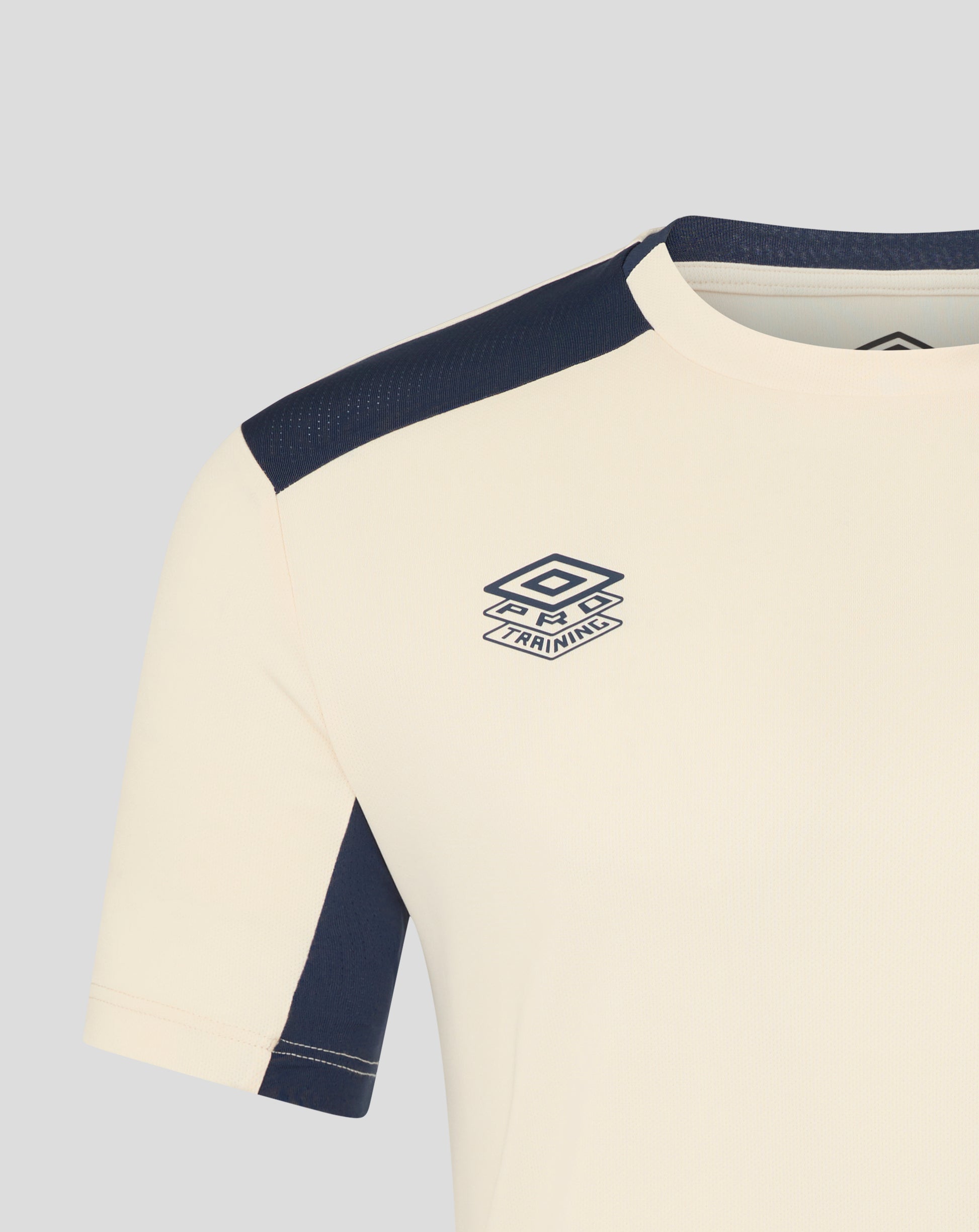 Cream training shirt with navy shoulder panels and West Ham crest