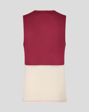Back view of a burgundy West Ham training sleeveless shirt with a cream hem on a mannequin