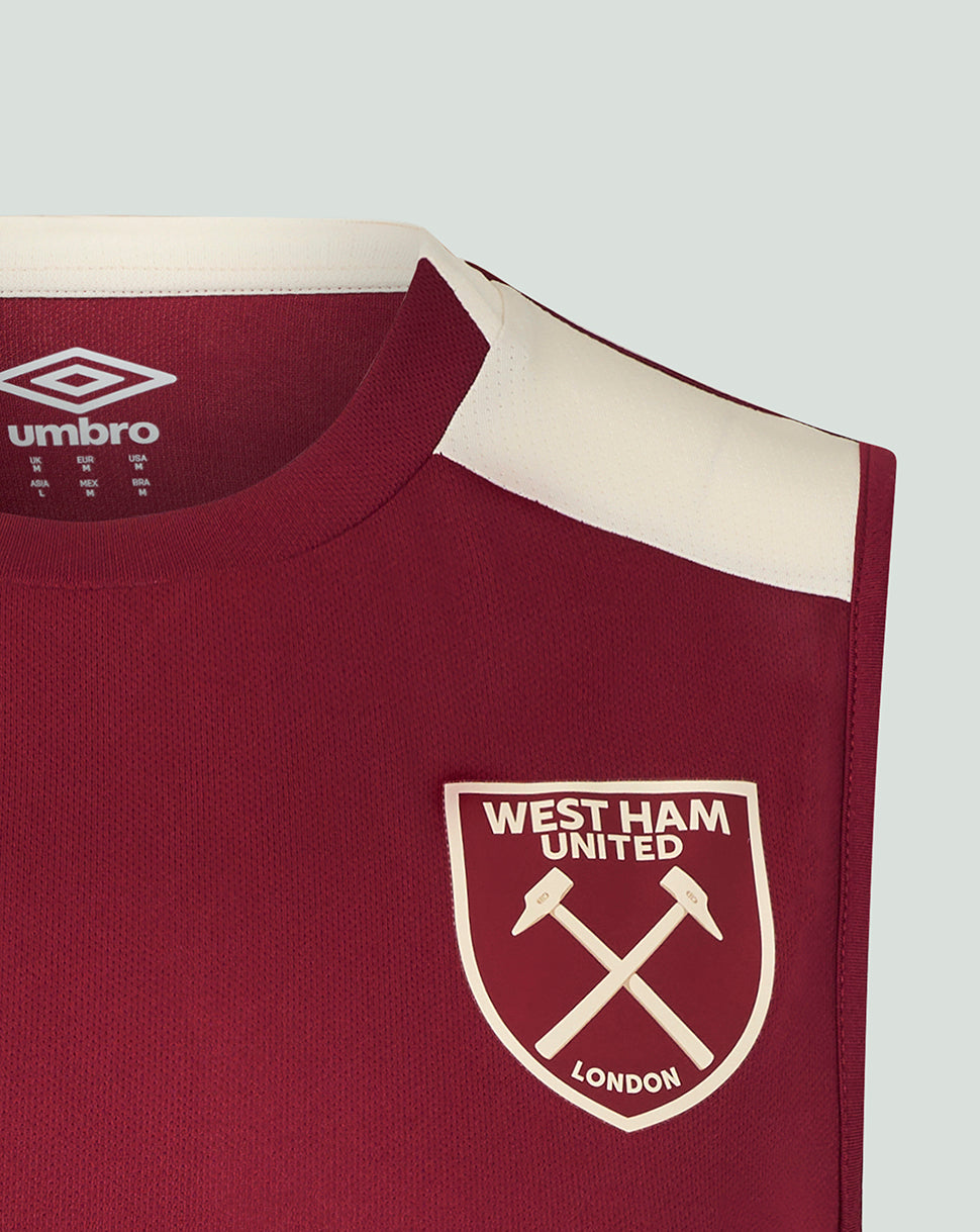 Shoulder close-up of burgundy West Ham 25/26 pro training sleeveless shirt with a cream panel and crest