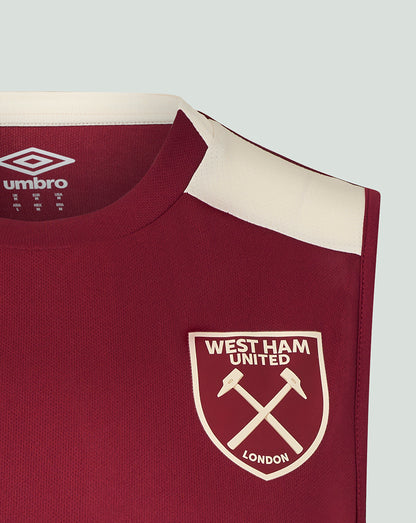 Shoulder close-up of burgundy West Ham 25/26 pro training sleeveless shirt with a cream panel and crest