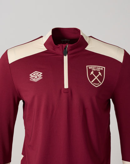 Close-up of burgundy West Ham training top showing collar zipper and left chest crest.