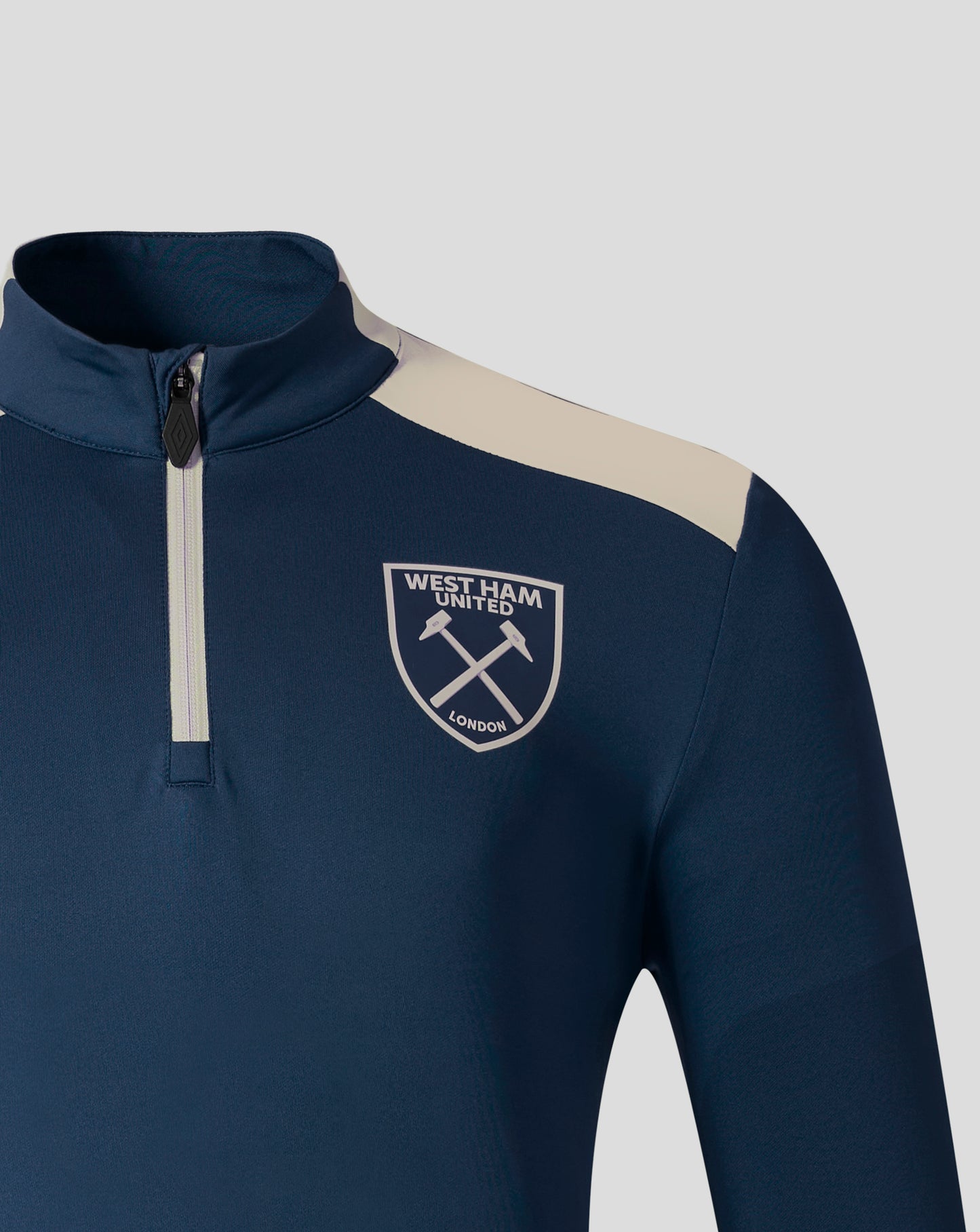 Navy West Ham Pro Training midlayer top with beige shoulder panel and club crest on the chest.