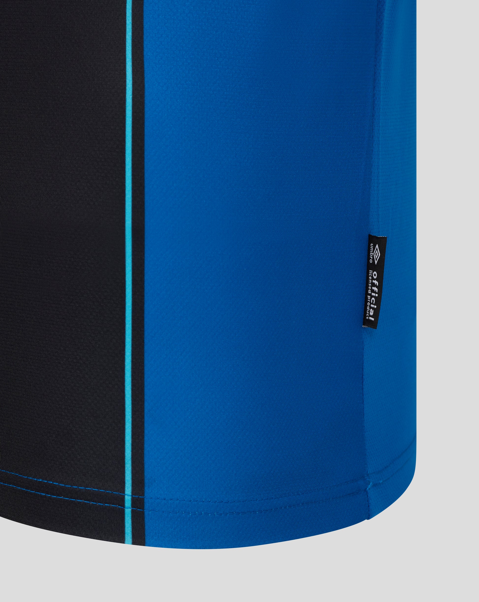 Close-up of AFC Bournemouth home shirt fabric in blue with black panel and turquoise piping.