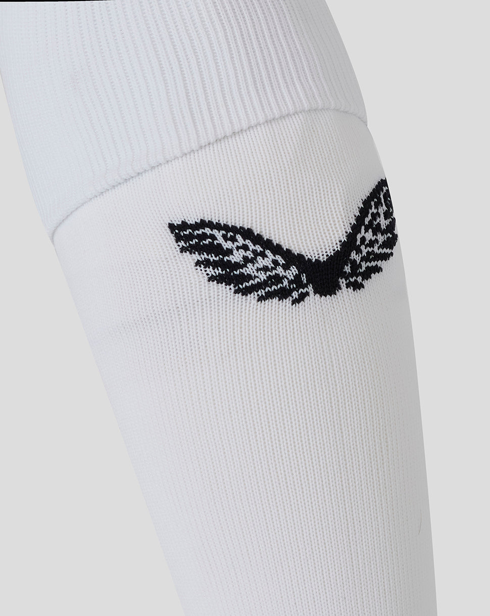 Close-up of white Bath Rugby Junior Away Sock with a small black emblem on the cuff