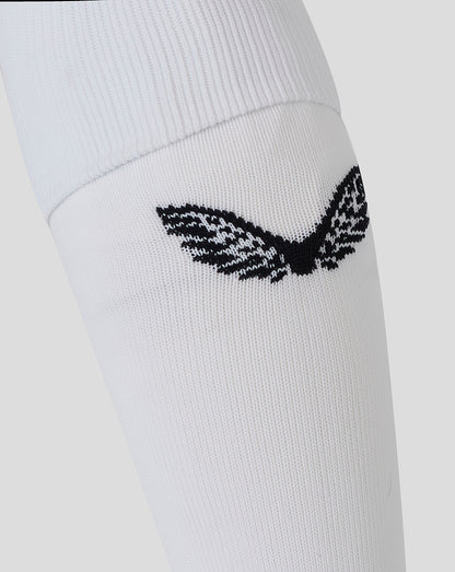 Close-up of white Bath Rugby Junior Away Sock with a small black emblem on the cuff