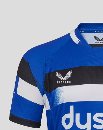 Shoulder and sleeve close up of Bath Rugby junior home replica shirt with blue panels white stripe and cuff.