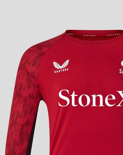 Shoulder and chest view of Saracens training long sleeve tee showing crest and large StoneX branding on a red patterned sleeve.
