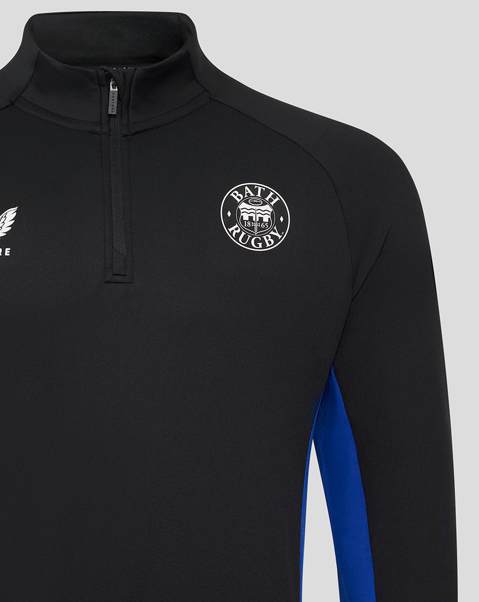 Close-up of Bath Rugby midlayer showing chest crest and partial zipper on black fabric