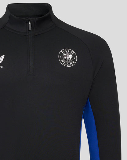 Close-up of Bath Rugby midlayer showing chest crest and partial zipper on black fabric