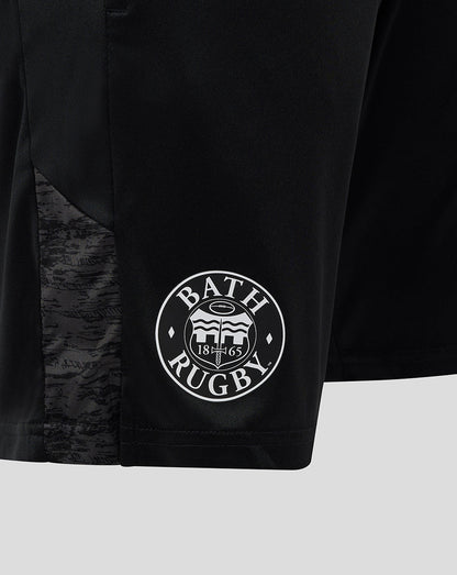 Close-up of the Bath Rugby crest on the lower left leg with textured fabric panel beside it.