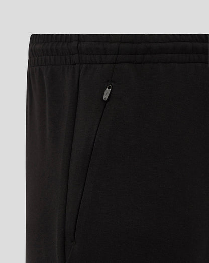 Close up of black Bath Travel Knit Pants showing elastic waistband and zippered side pocket