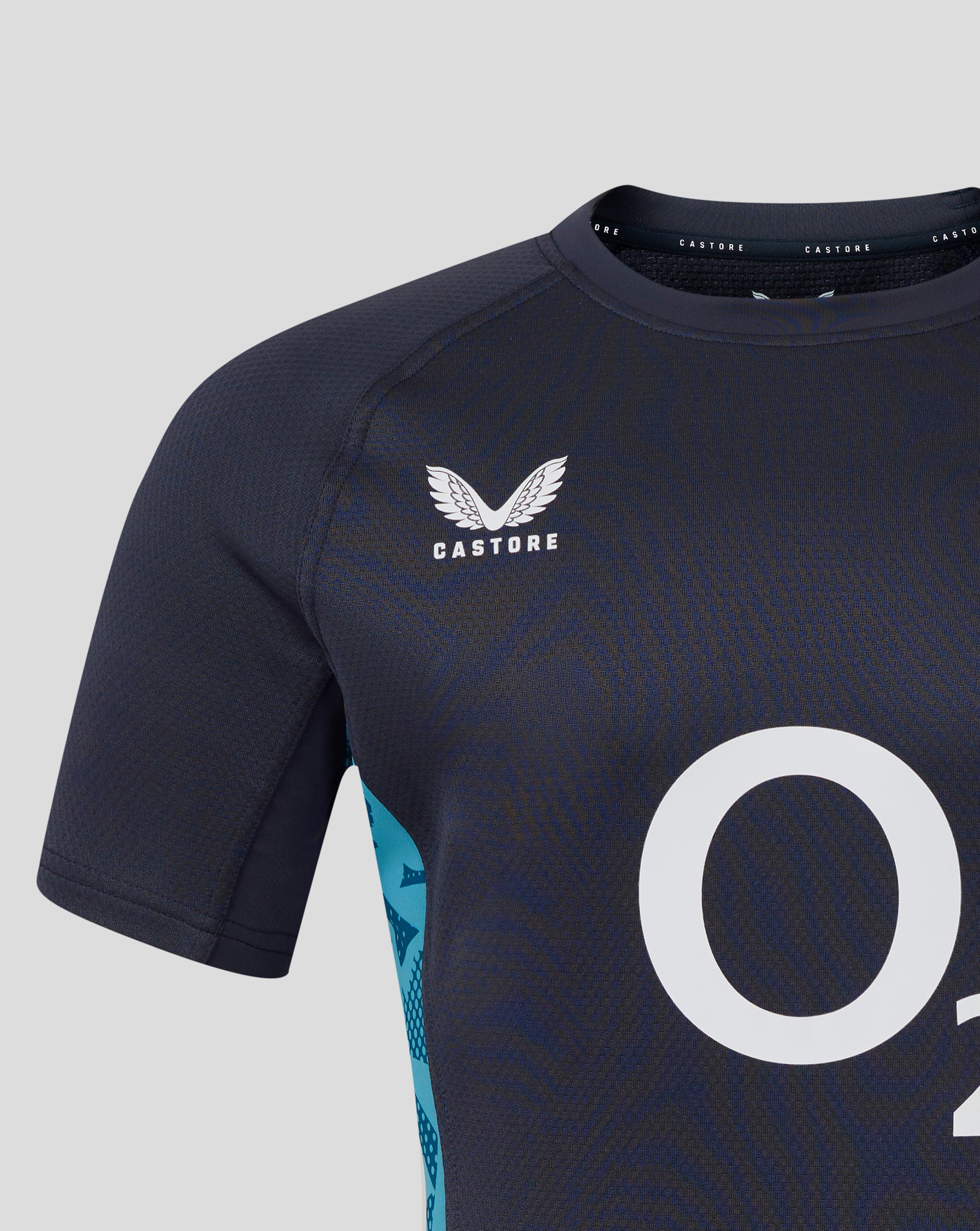 Close-up of navy England Rugby short sleeve jersey showing textured fabric and Castore logo near the collar with a partial white number