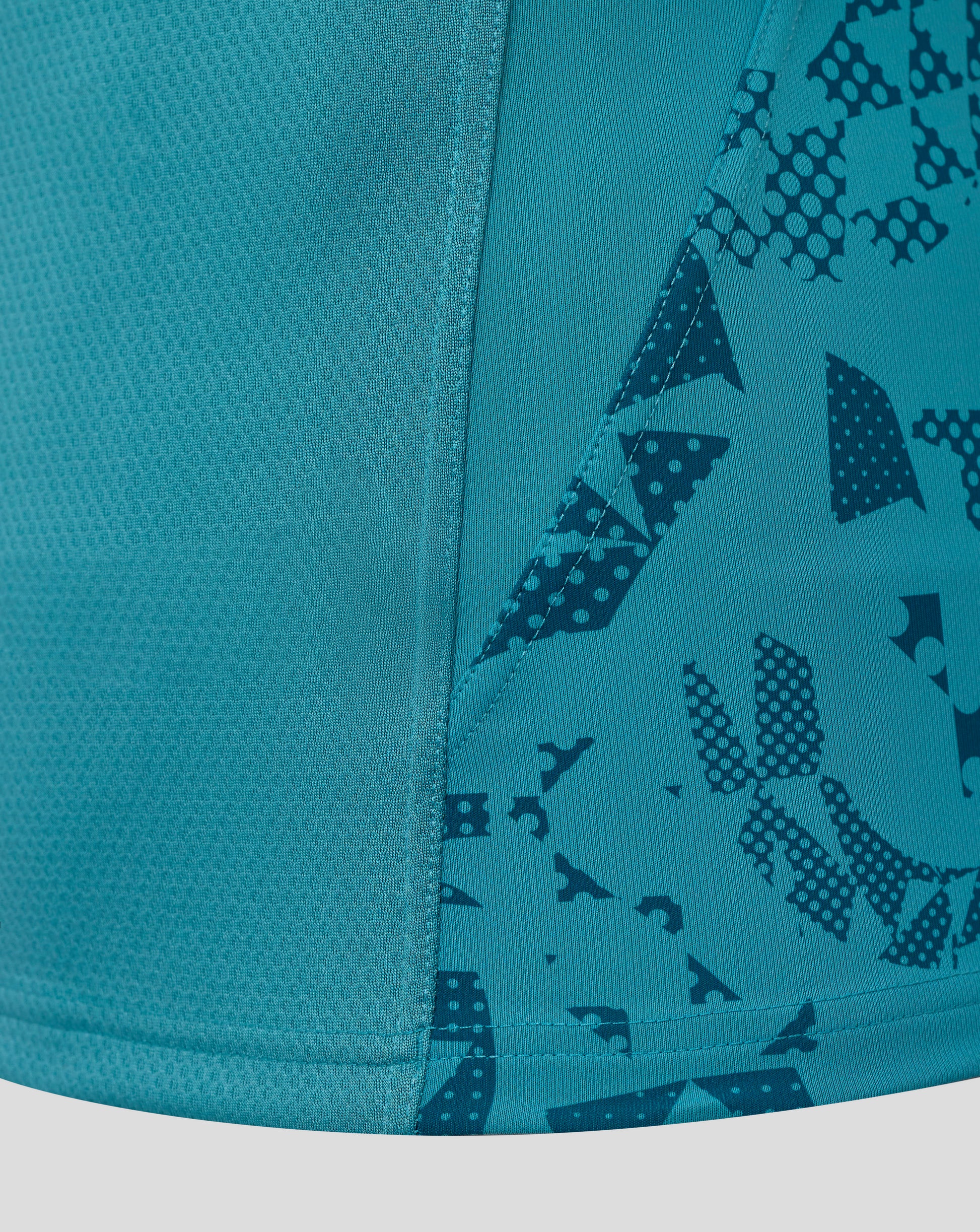 Close-up of teal fabric and seam on England Rugby Men's Contact Short Sleeve Jersey featuring a geometric print.