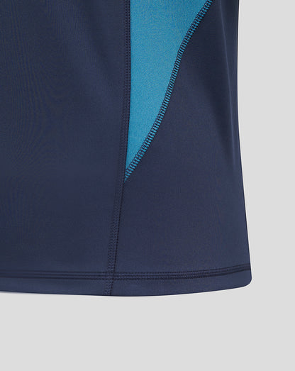 Close-up of navy rugby drill top showing turquoise side panel and two-panel sleeves