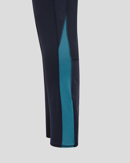 Side view of navy drill pants showing a teal side panel along the leg and contrast stitching