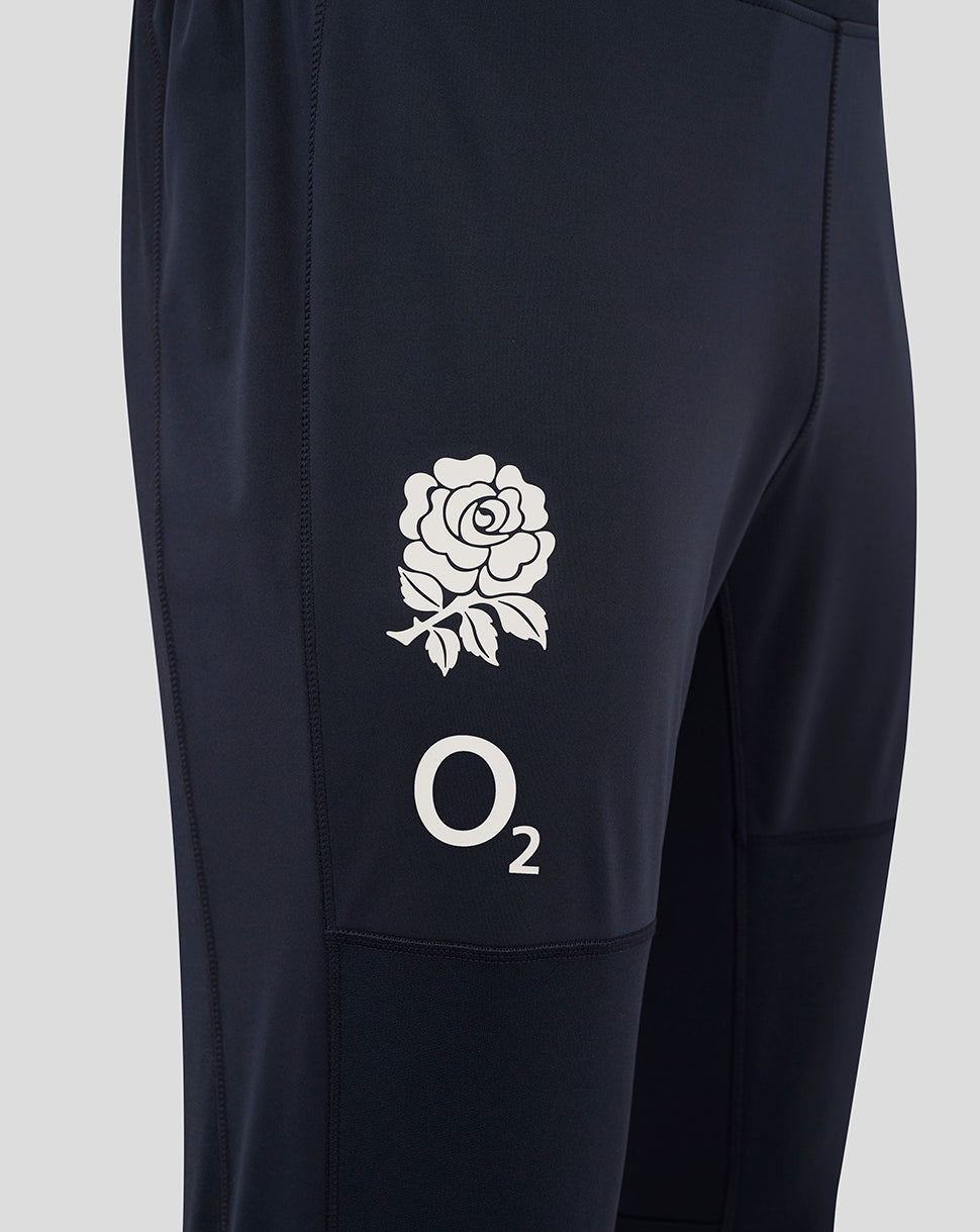 Close-up of the thigh on navy drill pants showing the white rose crest and O2 logo