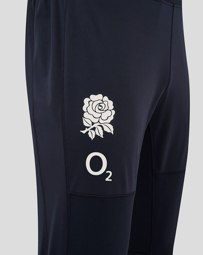 Close-up of the thigh on navy drill pants showing the white rose crest and O2 logo