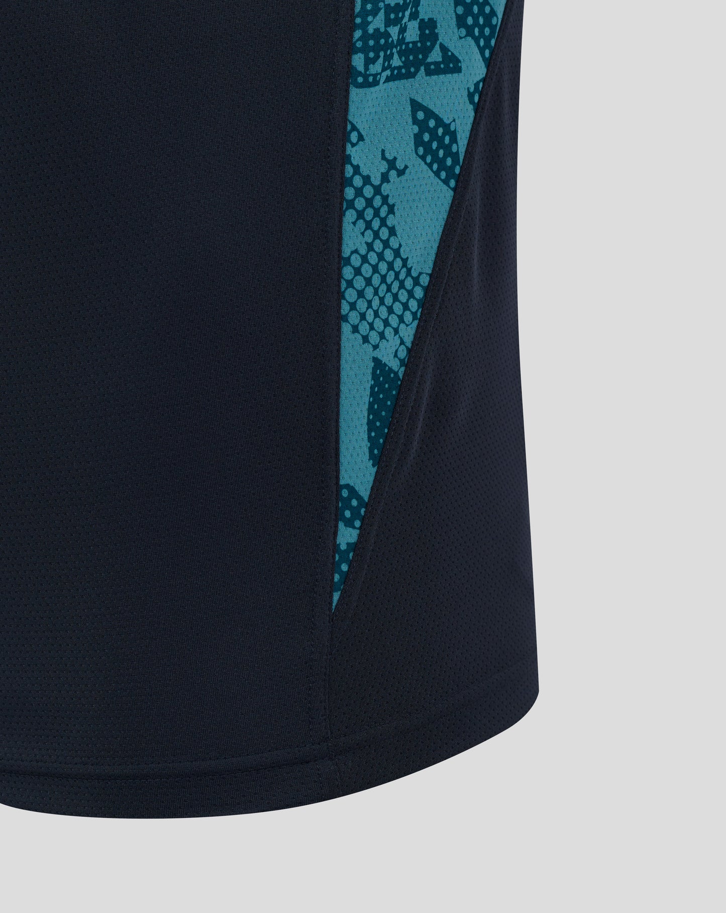 Close up of navy England Rugby performance T shirt with teal abstract side panel pattern along the seam