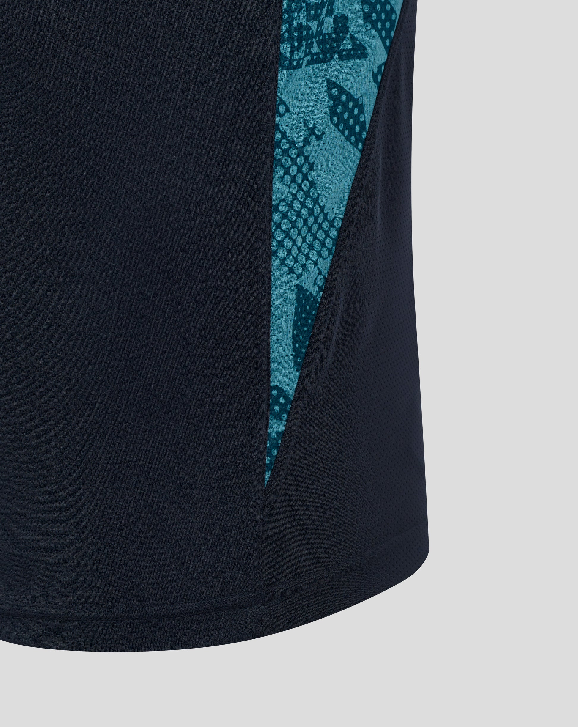 Close up of navy England Rugby performance T shirt with teal abstract side panel pattern along the seam