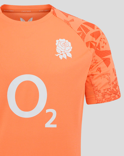 Close-up of melon orange England rugby performance shirt showing a white rose crest on the chest and patterned sleeve panels