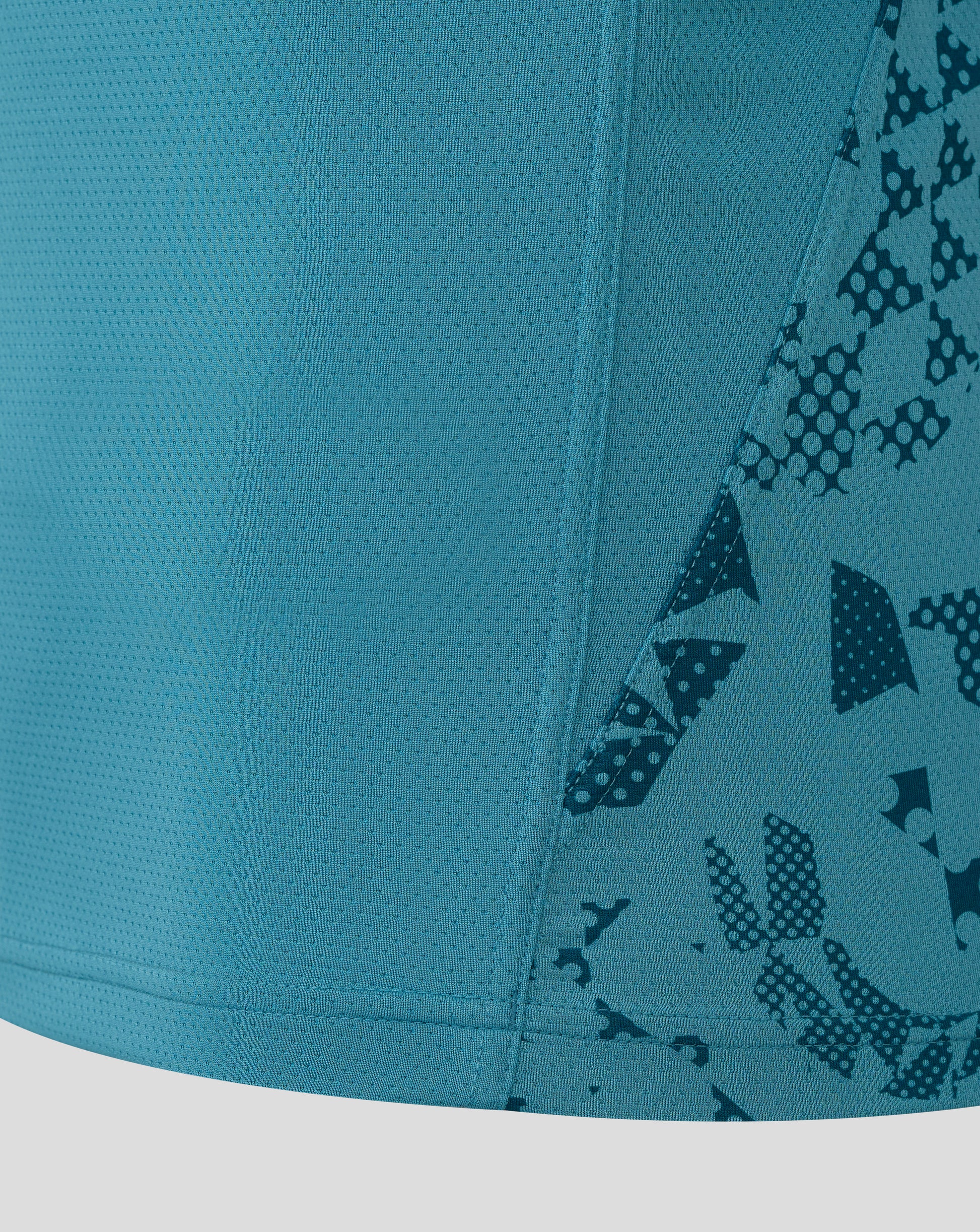 Close up of storm blue England Rugby performance fabric with a dotted mesh texture and diagonal patterned panel