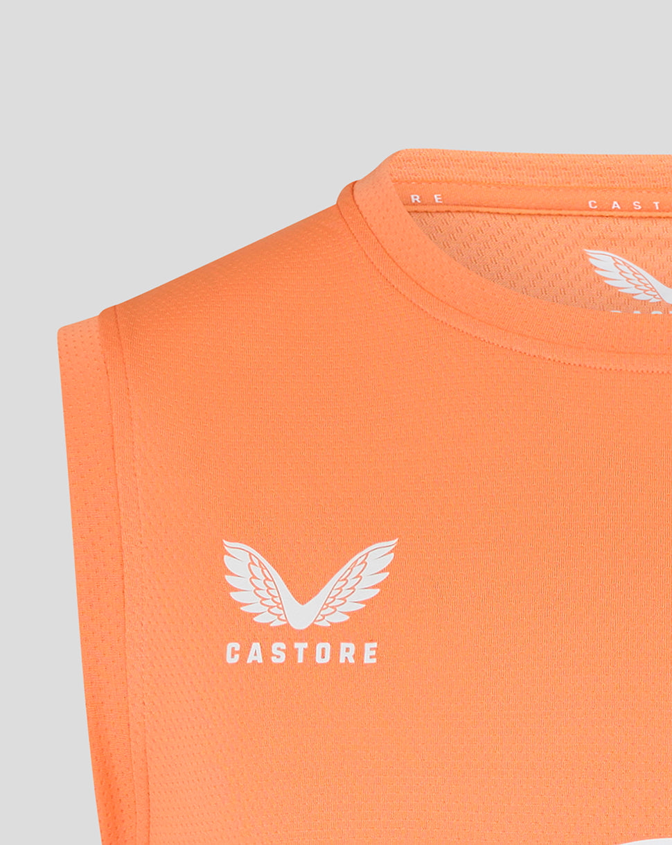 Close up of Castore logo and wing on melon orange sleeveless rugby T shirt