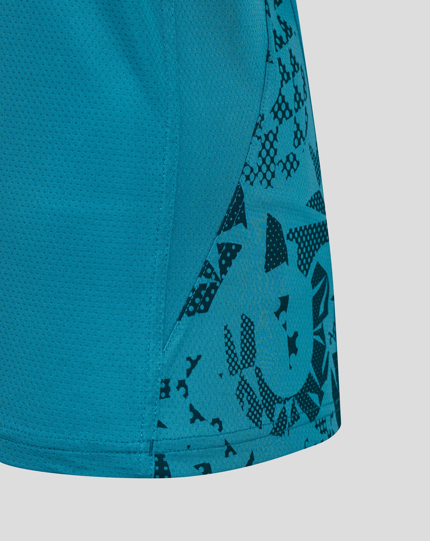 Close up of storm blue rugby sleeveless shirt fabric showing breathable mesh and a patterned side panel
