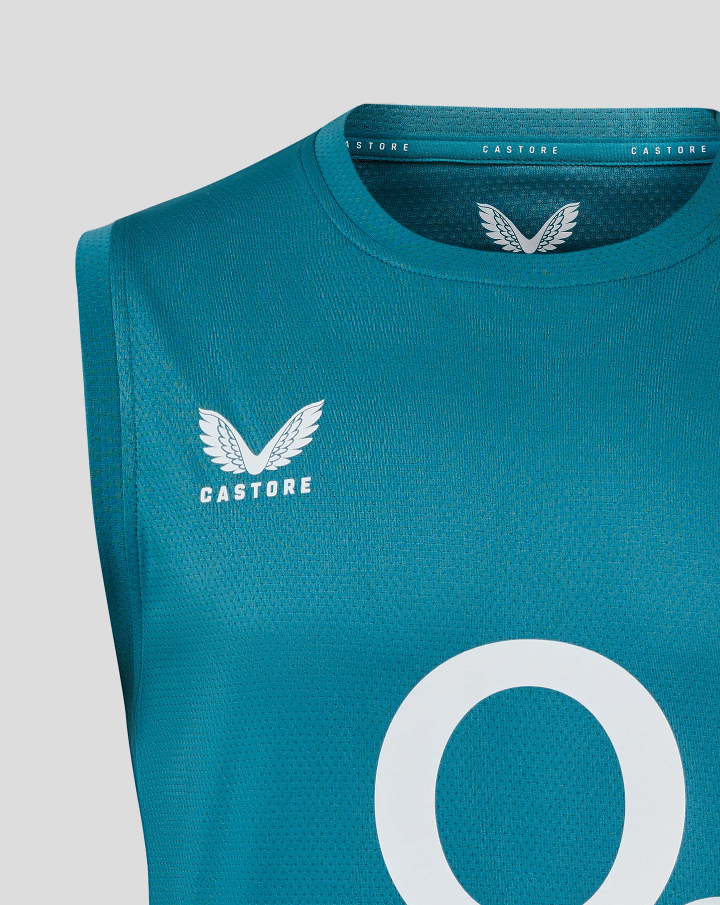 Close-up of teal sleeveless rugby shirt fabric featuring the white rose crest on the chest, central O2 logo, and Castore branding at the neckline.