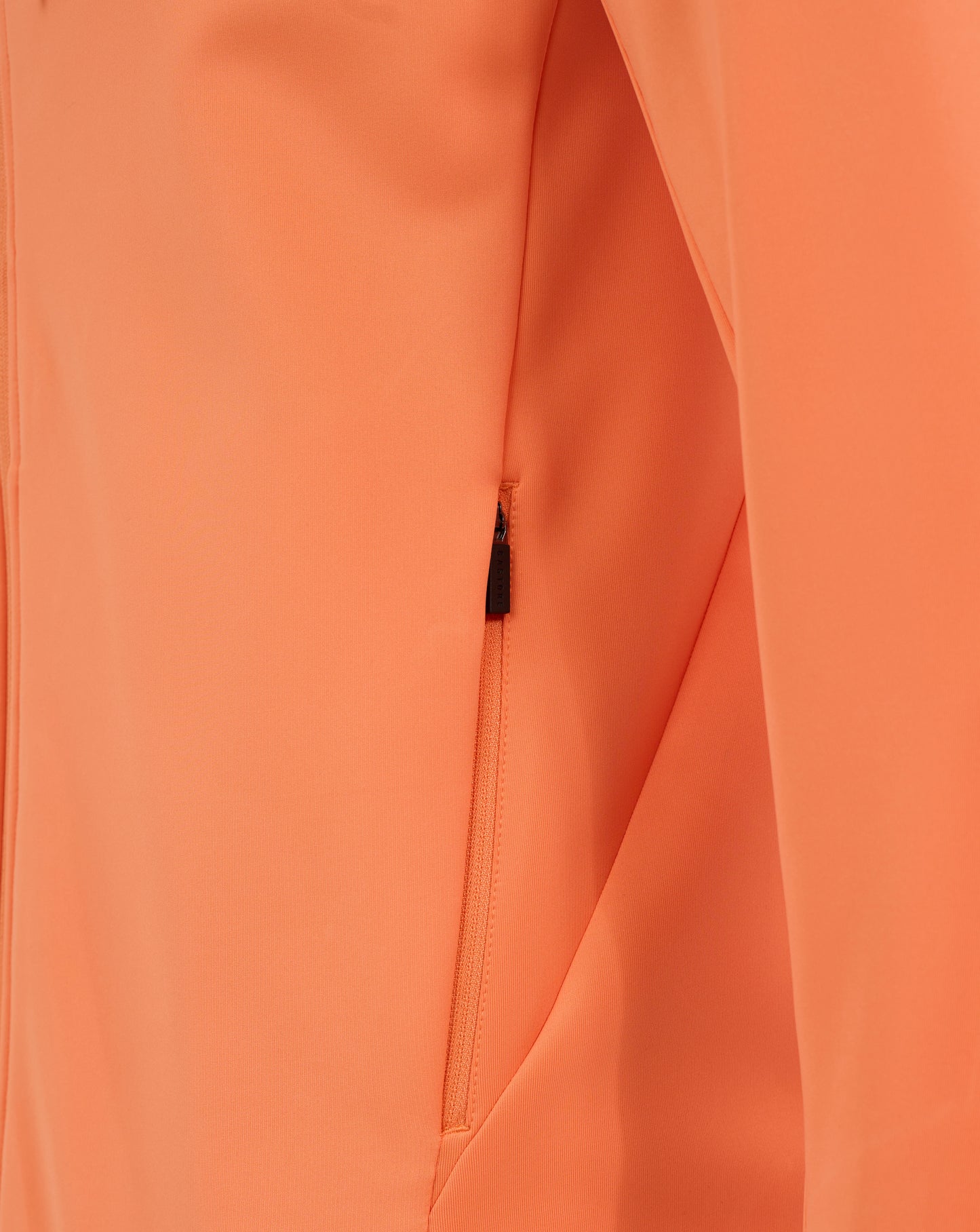 Close-up of orange Melon fabric with a visible zipper and seam on a men's England Rugby performance hoodie