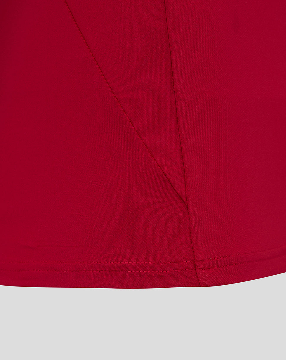 Close-up of red fabric from England Rugby drill top with seam lines and curved hem