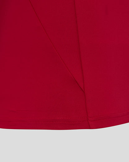 Close-up of red fabric from England Rugby drill top with seam lines and curved hem