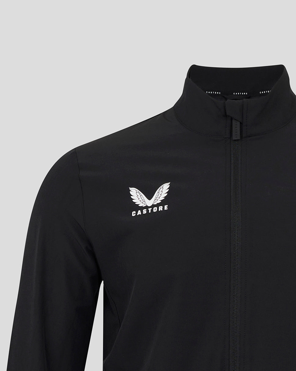 Close up of black England Rugby Alternate Anthem jacket showing white wing crest and Castore logo on the chest beside the zipper