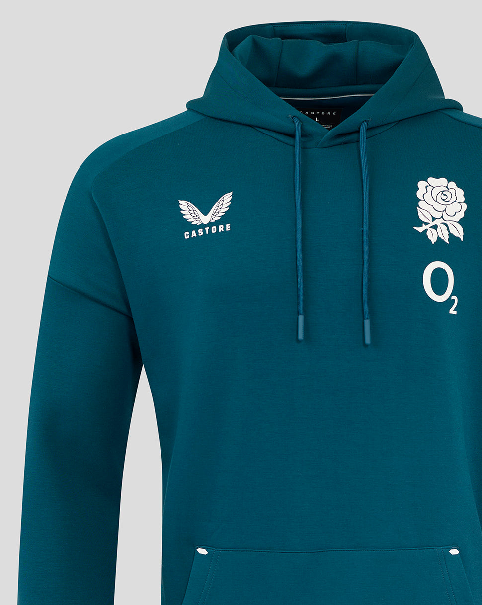 Close-up of the teal hoodie chest showing Castore logo on the left and a white rose with O2 emblem on the right