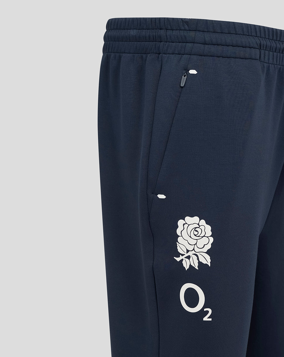 Navy England Rugby Travel Knit Pant closeup showing zip pocket and O2 rose logo on the thigh