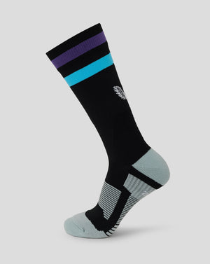 Black mid calf sock with purple and teal stripe bands and Castore logo on the back leg.